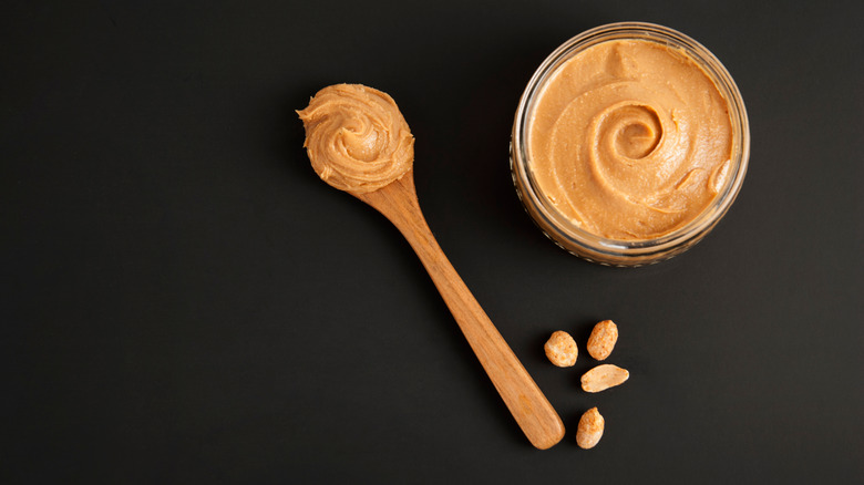 A bowl and a spoon of peanut butter