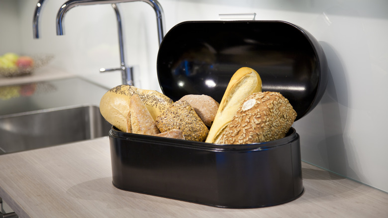 Seedy bread in front of bread box