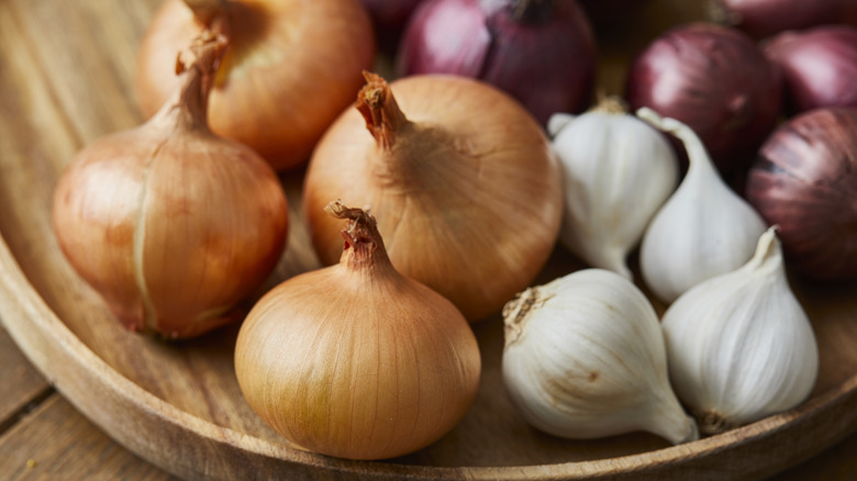onions displayed on open wooden bowl