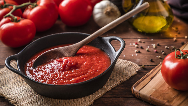 Tomato sauce with wooden spoon