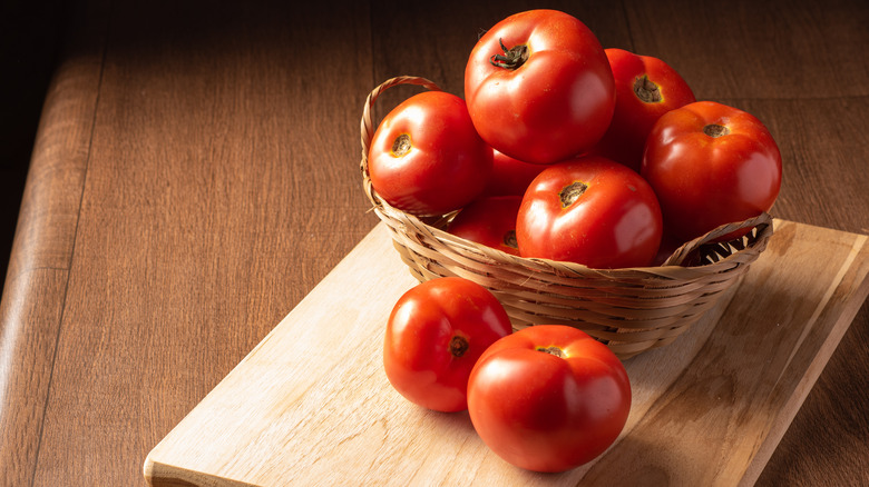 Red tomatoes in wicker basket 