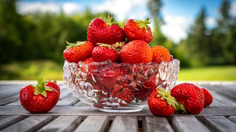 Glass bowl of strawberries on table