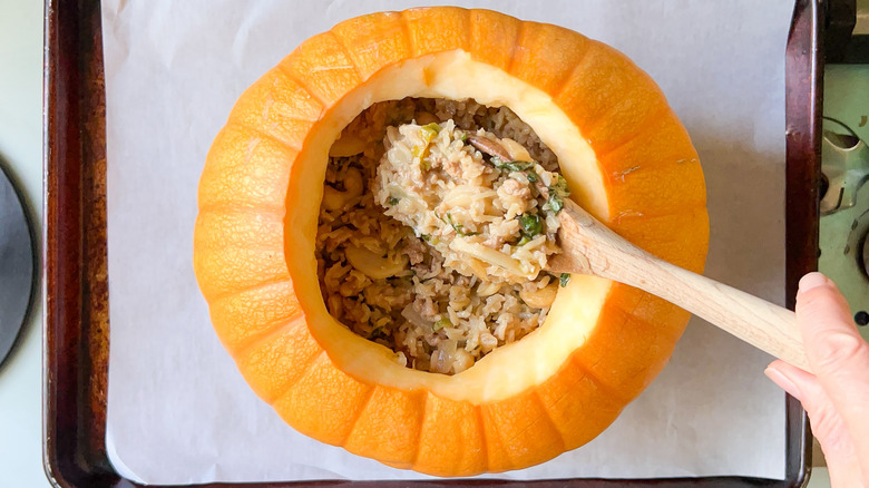 Filling pumpkin with rice mixture