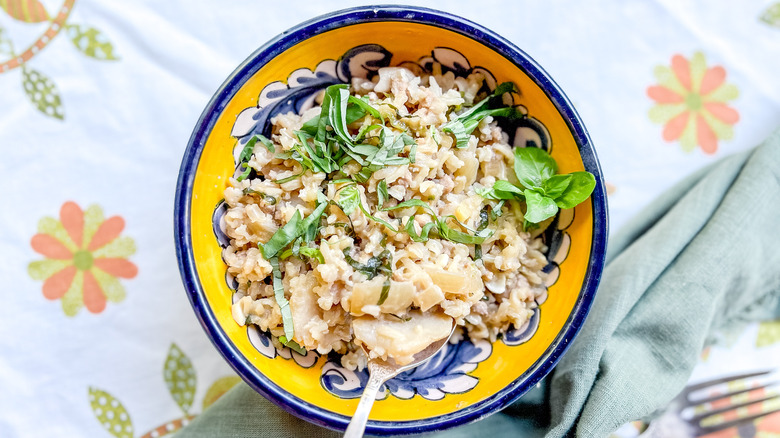 Aromatic rice with basil and pumpkin on table
