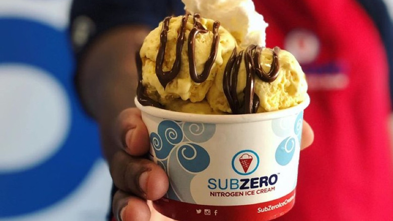 Person holding a cup of Sub Zero Nitrogen Ice Cream