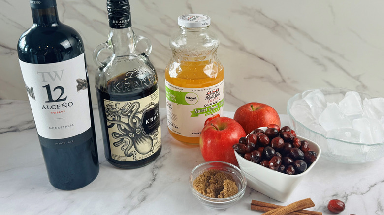 Sugar and spice Thanksgiving sangria ingredients lined up on a counter