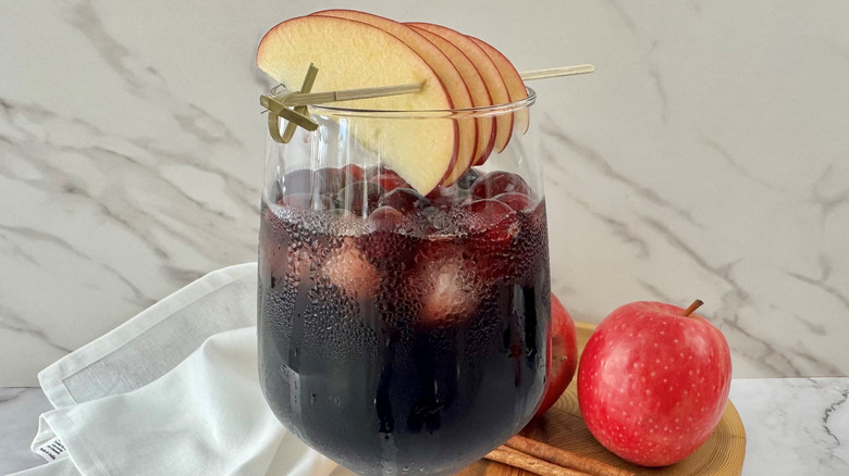 sangria in a glass with sliced apple garnish