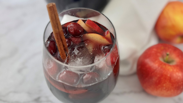 Sangria in a glass with a cinnamon stick garnish