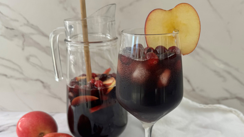 Sangria in a jug with sliced apple garnish