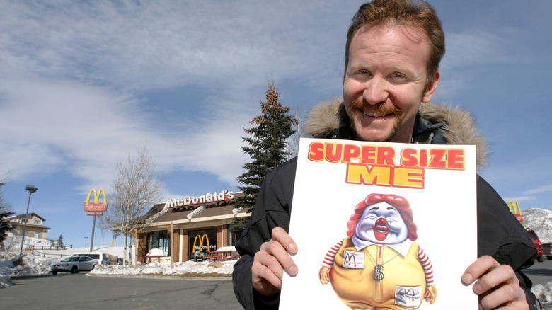 Morgan Spurlock holding poster for Super Size Me documentary
