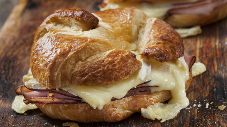 Croissant sandwich filled with melted cheese