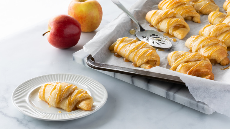 Baked apple filled crescent rolls on sheet pan