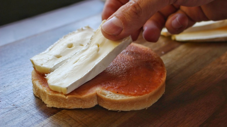 placing brie on bread