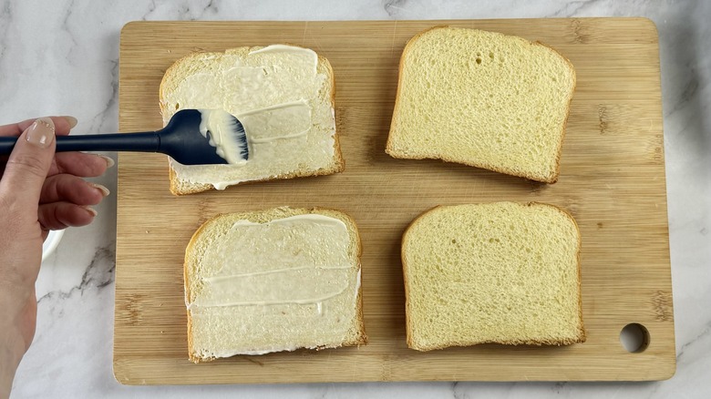 spreading mayo on sandwich bread