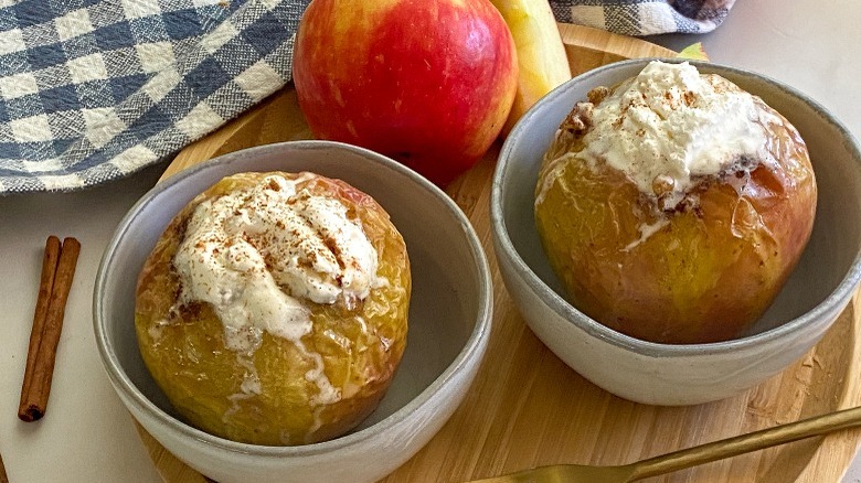 baked apples with whipped cream in bowls