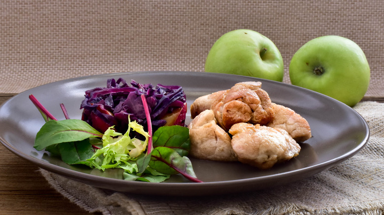 Sauteed sweetbreads on plate with green apples