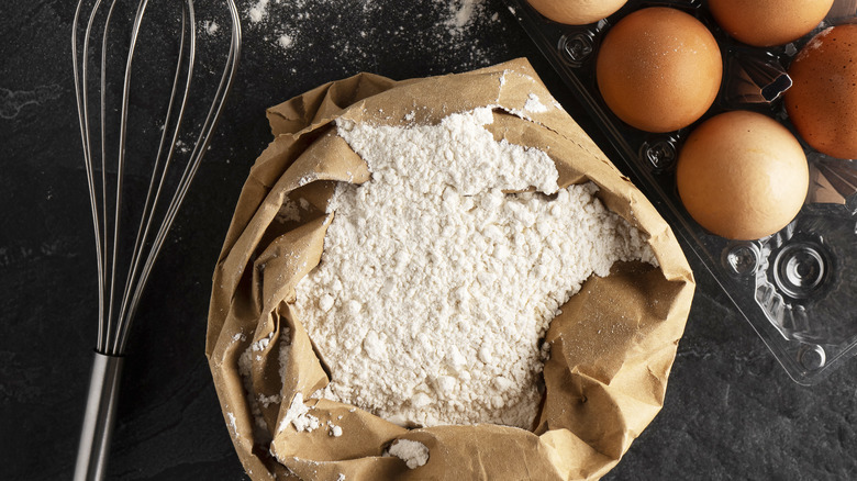 Flour in bag with eggs and whisk