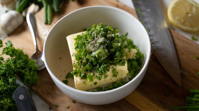 Bowl of butter and green herbs