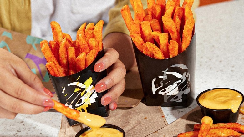 Person holding Taco Bell vegan nacho fries