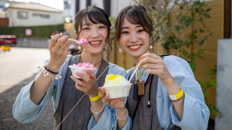 Two women eating kakigōri