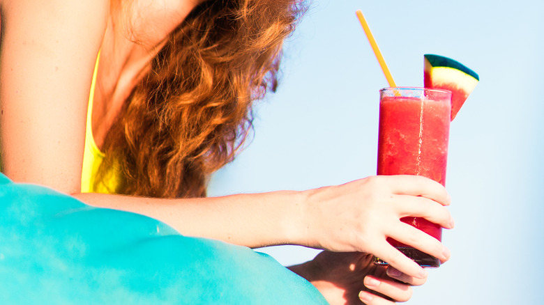 Person holding watermelon drink