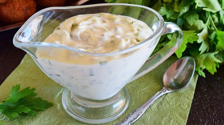 Tartar sauce in serving boat next to spoon