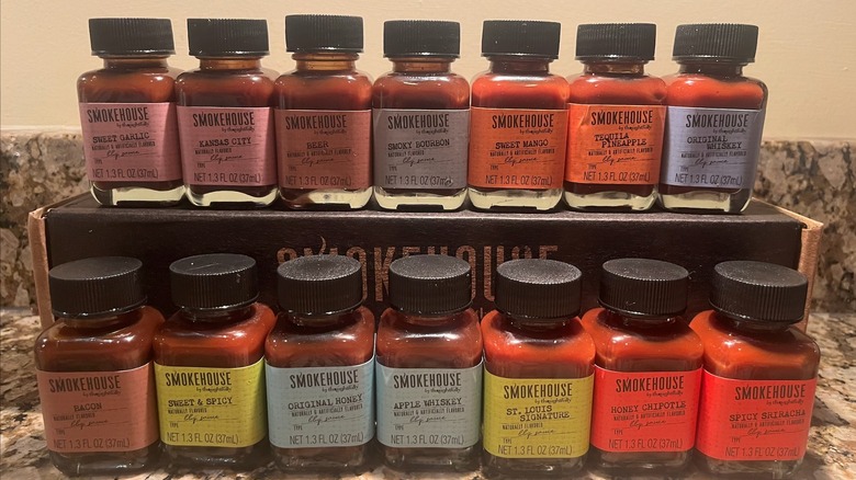 14 bottles of Smokehouse by Thoughtfully BBQ sauce arranged in two rows