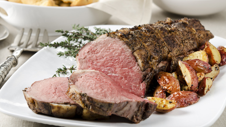 Cooked beef tenderloin sliced on plate