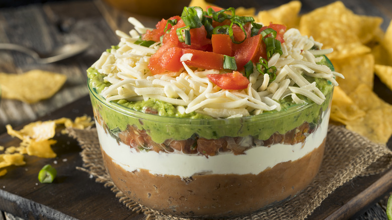 Layered bean dip in glass container