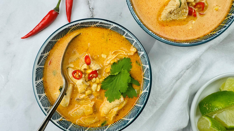 Thai peanut soup in bowl with garnishes