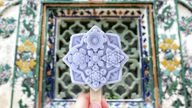 Floral purple popsicle in front of tiles