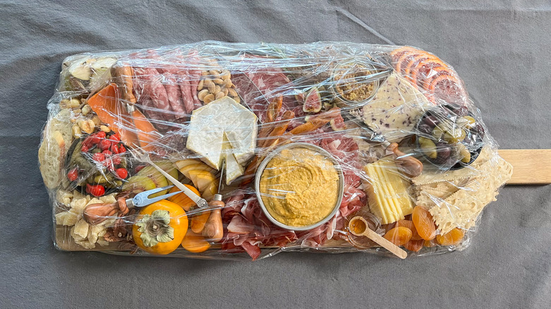 thanksgiving charcuterie board wrapped for transporting