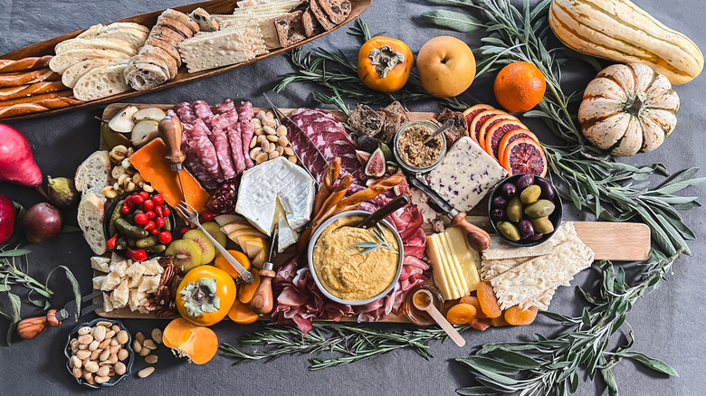 Thanksgiving charcuterie board with pumpkin-sage hummus and garnishes