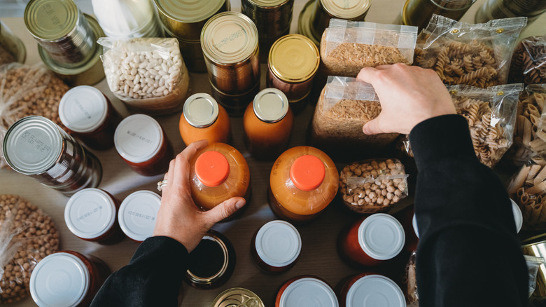 woman choosing canned goods