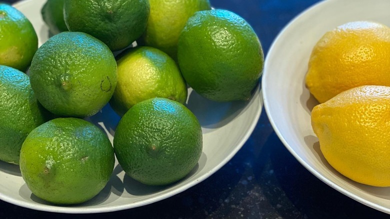 limes and lemons in white bowls