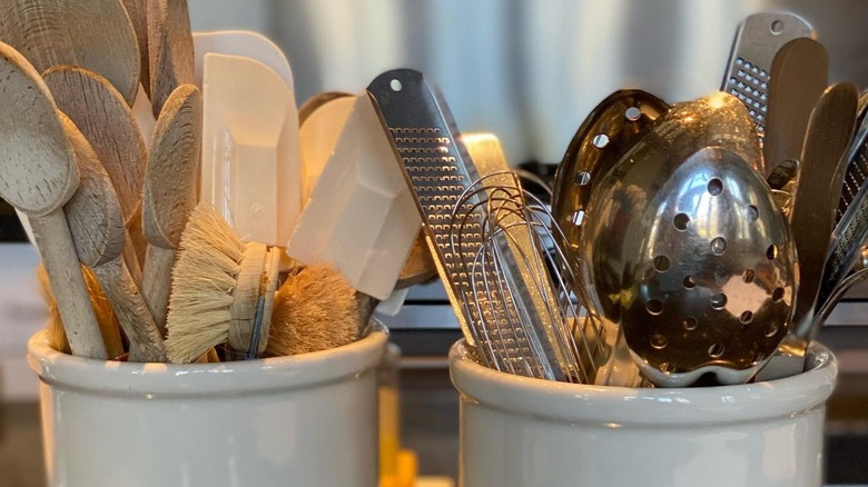 cooking utensils stored in crocks