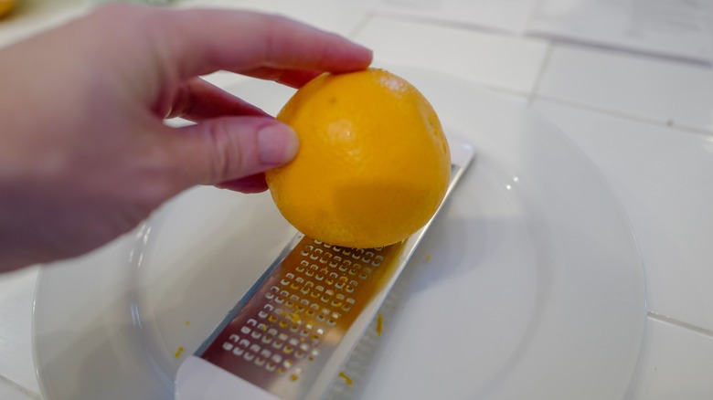 a person grating a lemon