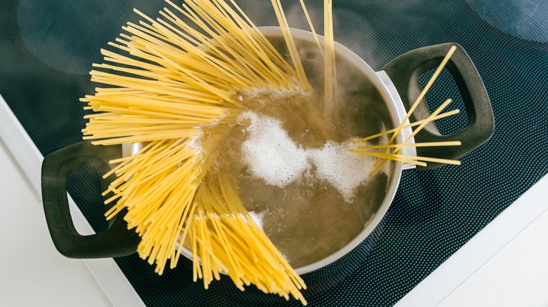 pasta being put into boiling water