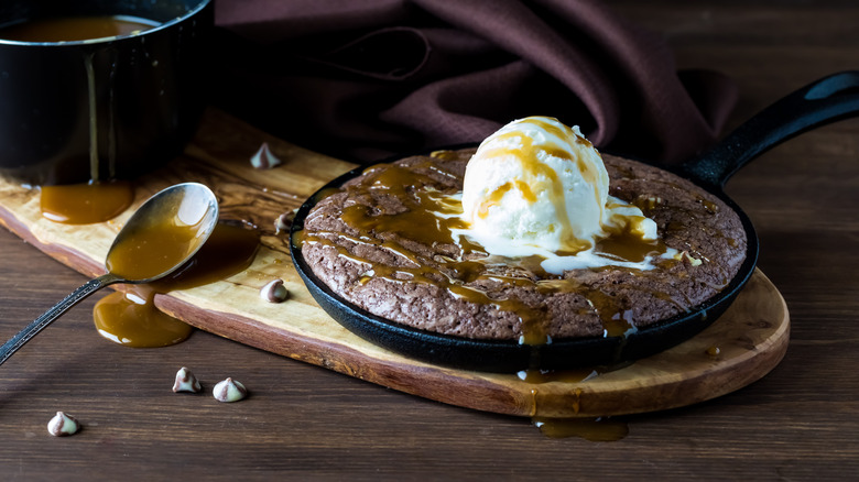 a skillet brownie topped in ice cream