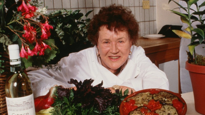 Julia Child smiling in kitchen