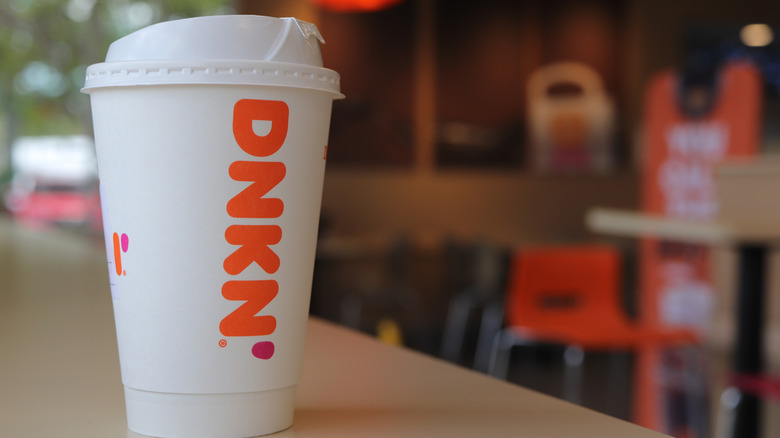 Close up of a Dunkin' coffee cup on a table