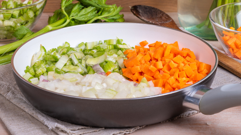 chopped celery, onion, and carrot in large skillet on table