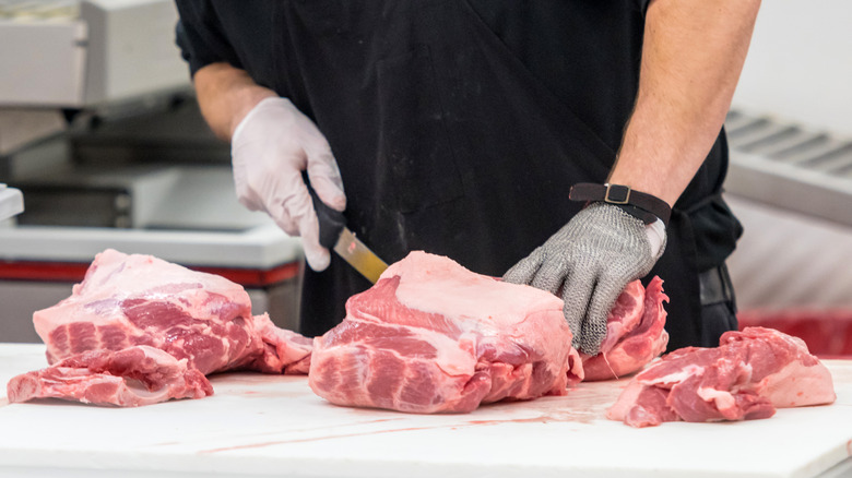 Butcher preparing meat