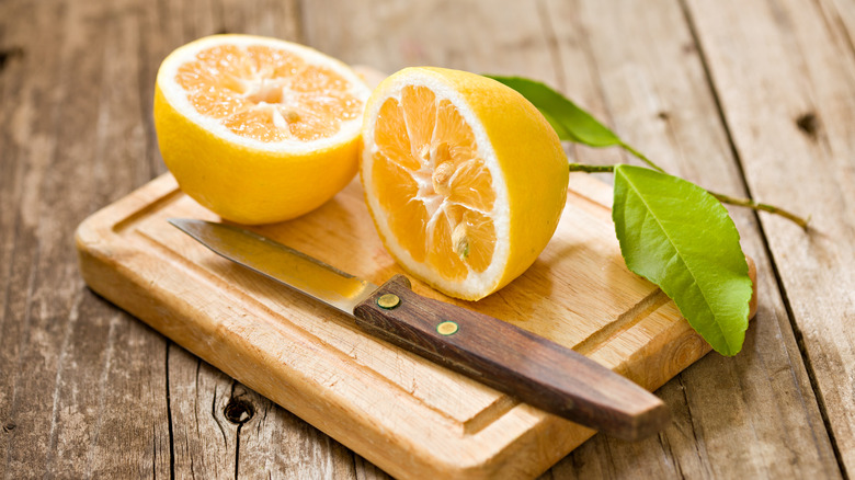 Lemon cut in half on wooden board