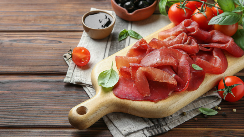 Bresaola on wooden cutting board