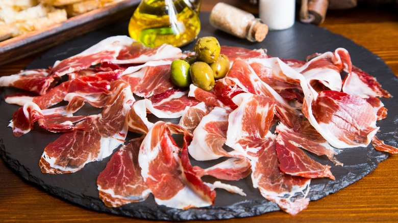 Jamón Ibérico slices with olives