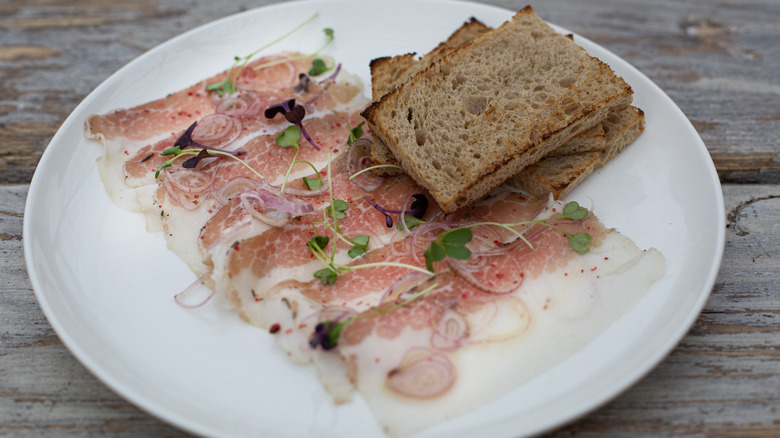 Lardo with toast on plate