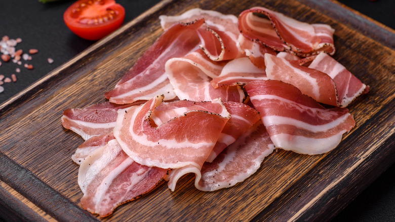 Pancetta slices on wood