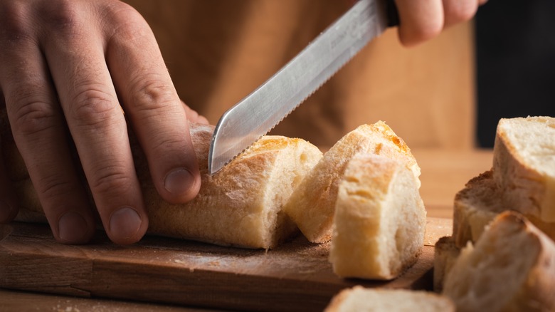 Slicing bread loaf with serrated knife