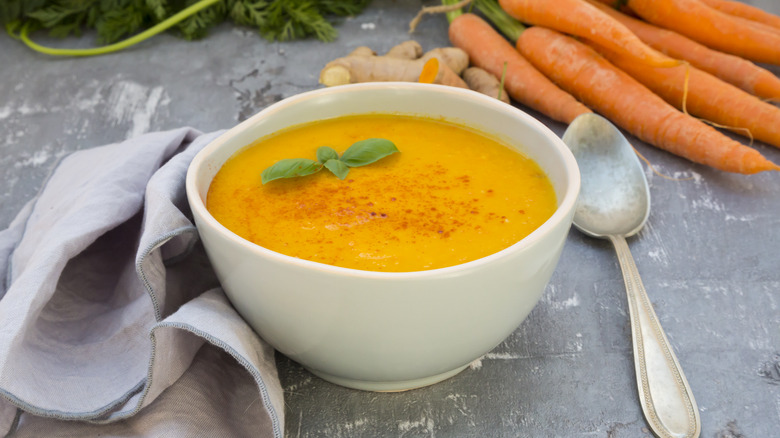 Bowl of creamy carrot soup in white bowl